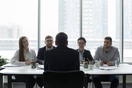 Hr managers interviewing job applicant and listening man
